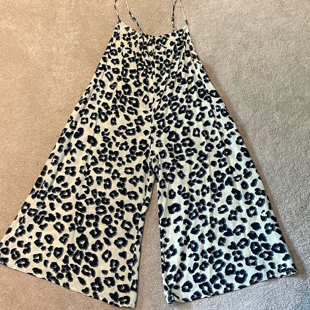 Cream animal print wide legged romper with spaghetti straps and pockets